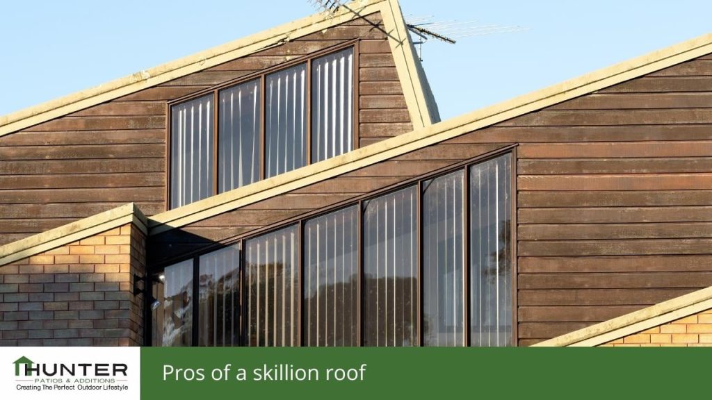 Modern house with sloped roof and large windows.