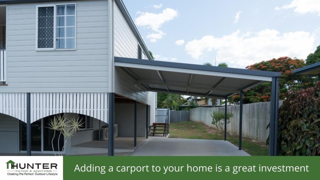 Adding a carport to your home is a great investment - Photo of a flat roof carport built off the side of a house.